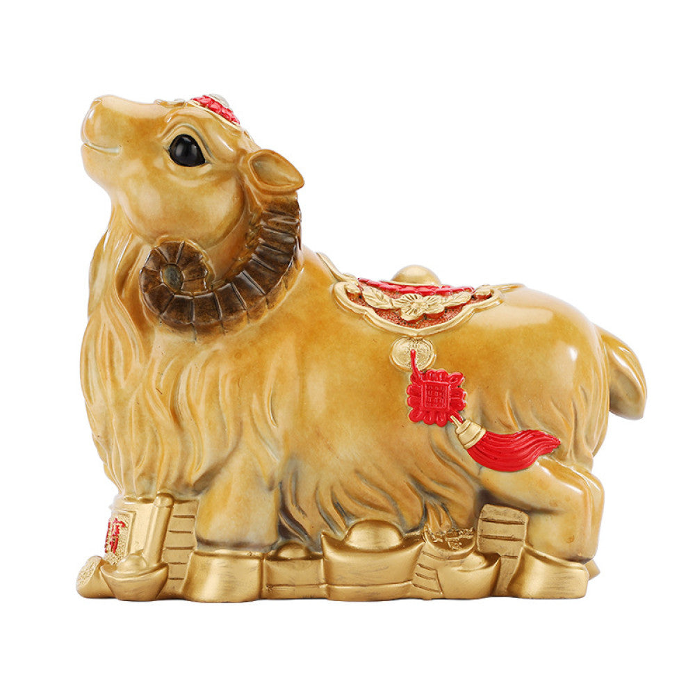 Golden camel statue with red accents and lucky details, a Feng Shui symbol of good fortune, displayed on a wooden base against a red background with a traditional fan decor 02
