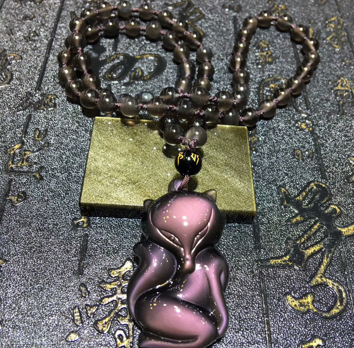 Natural obsidian fox amulet necklace with black beads and a jade accessory, perfect for those seeking symbolic and stylish jewelry