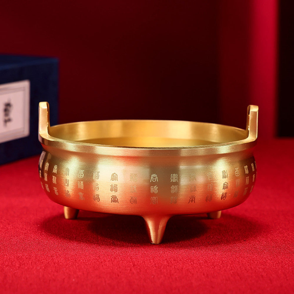 Golden bronze Chinese incense burner with double handles, three feet, and intricate fortune character carvings, a Feng Shui symbol of wealth and good luck, displayed as elegant home decor against a white background 02