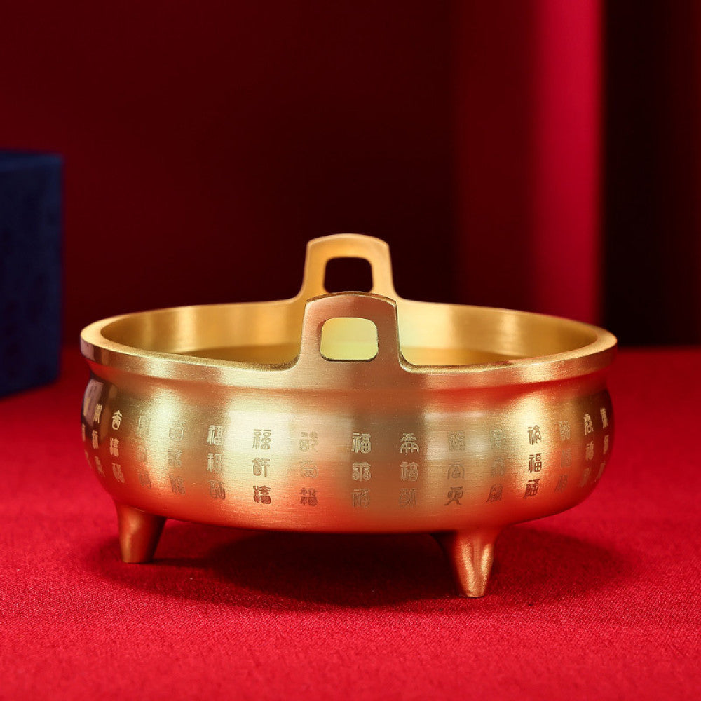 Golden bronze Chinese incense burner with double handles, three feet, and intricate fortune character carvings, a Feng Shui symbol of wealth and good luck, displayed as elegant home decor against a white background 03