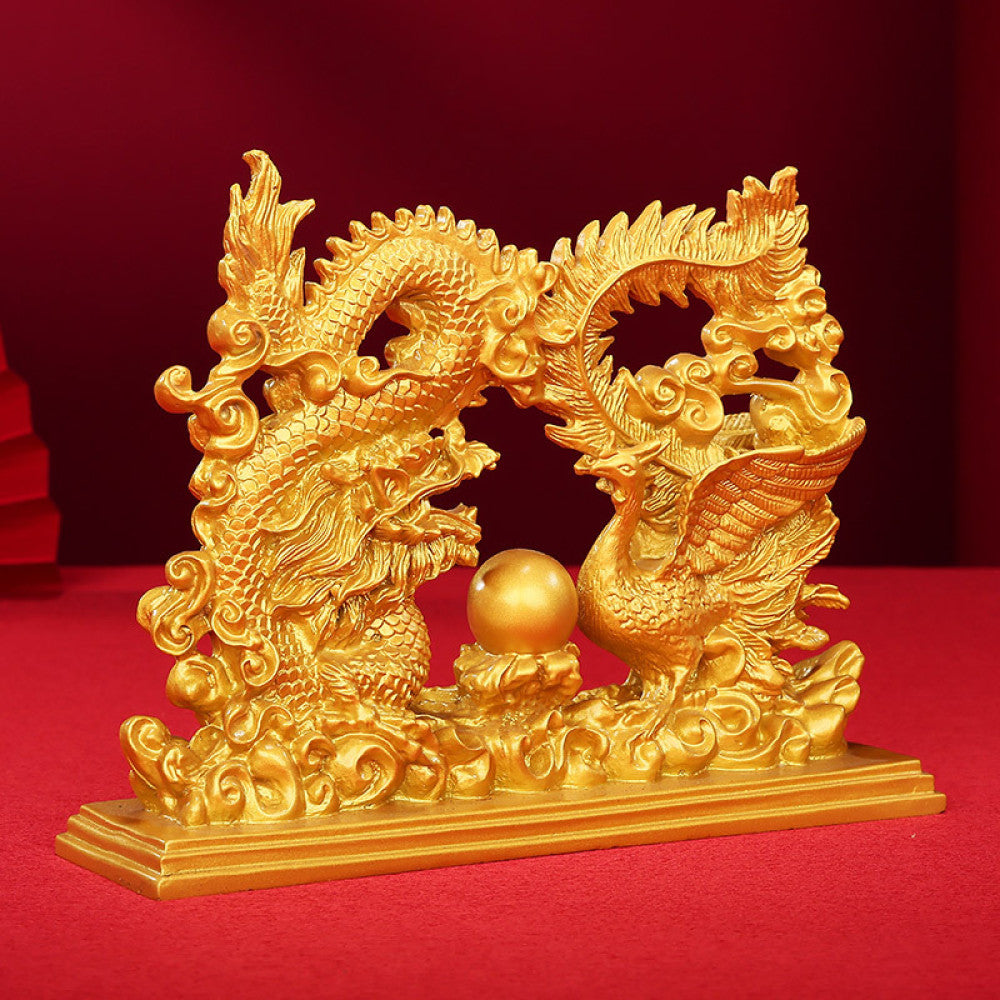 Golden dragon and phoenix statue with a central pearl, a Feng Shui symbol of harmony and good fortune, designed as elegant home decor against a red background 0