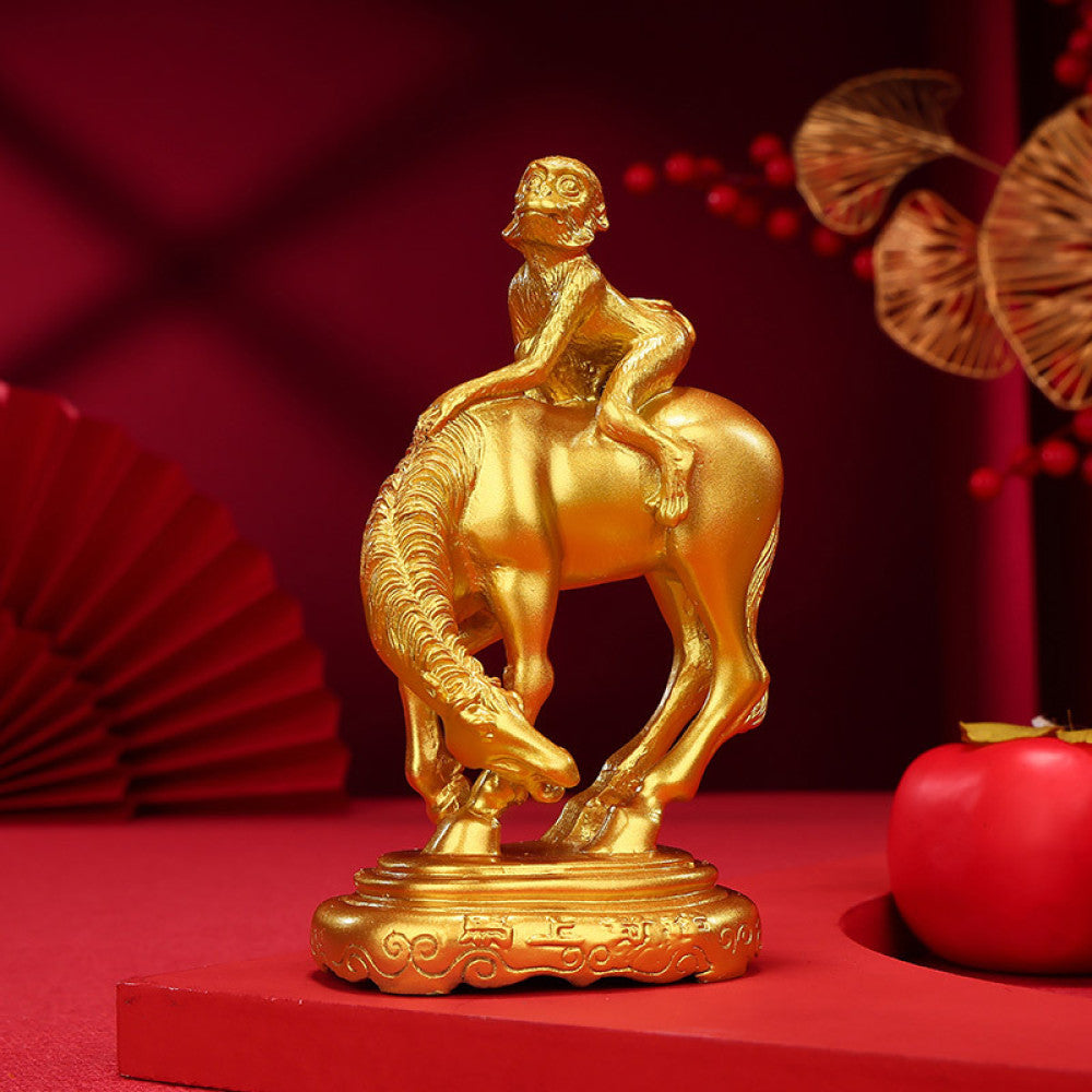 Golden monkey riding horse statue, a Feng Shui symbol of career success and good fortune, displayed as elegant home decor on a red background with traditional elements