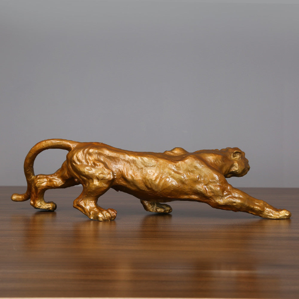 Golden panther statue with a dynamic running pose, featuring a metallic finish, ideal as an Art Deco home decor piece symbolizing strength and courage, displayed on a wooden surface against a gray background 02