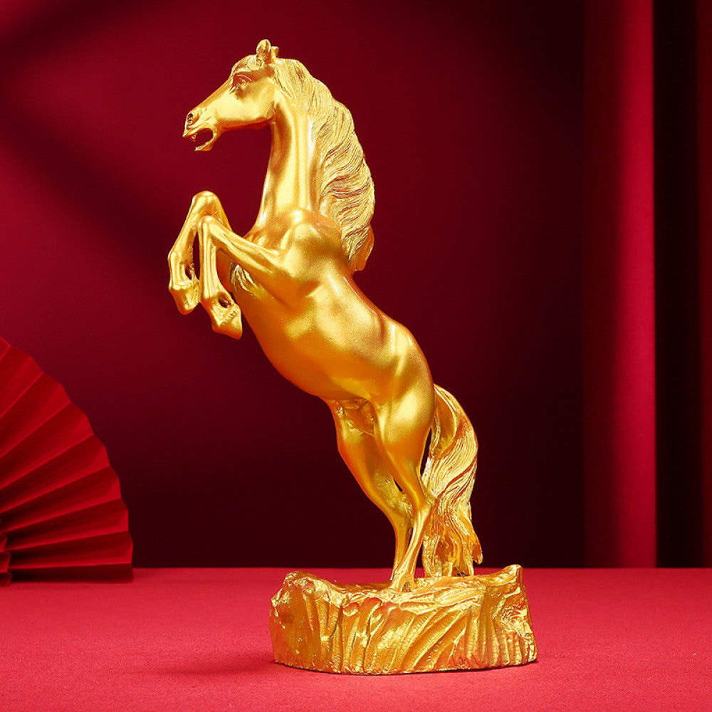 Golden rearing horse statue with a polished finish, a Feng Shui symbol of good fortune and strength, displayed as elegant home decor against a red background 01