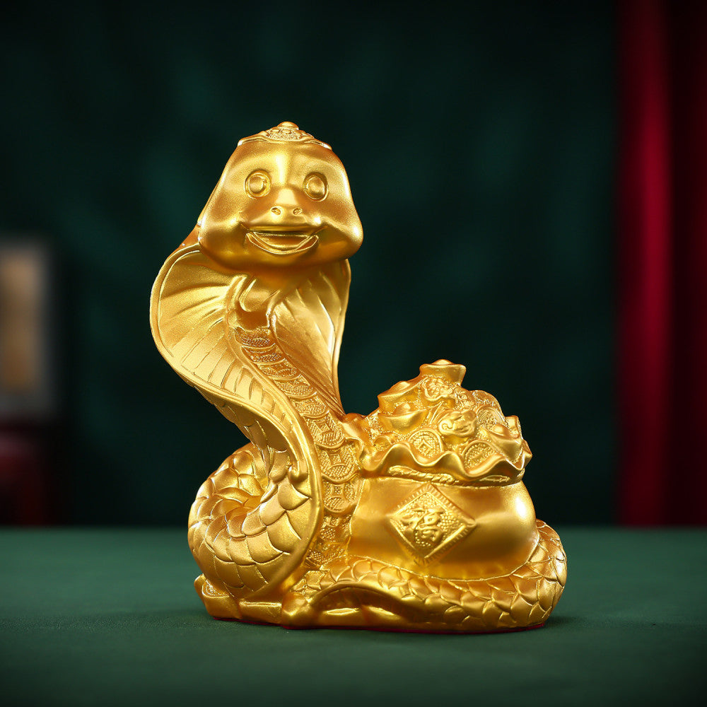Golden snake statue coiled around a treasure pot, a Feng Shui symbol of good fortune, crafted as stylish home decor against a dark green background