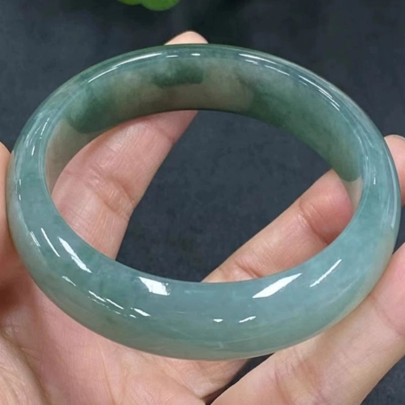 Hand holding icy green natural jade bangle, high translucency jade jewelry 02