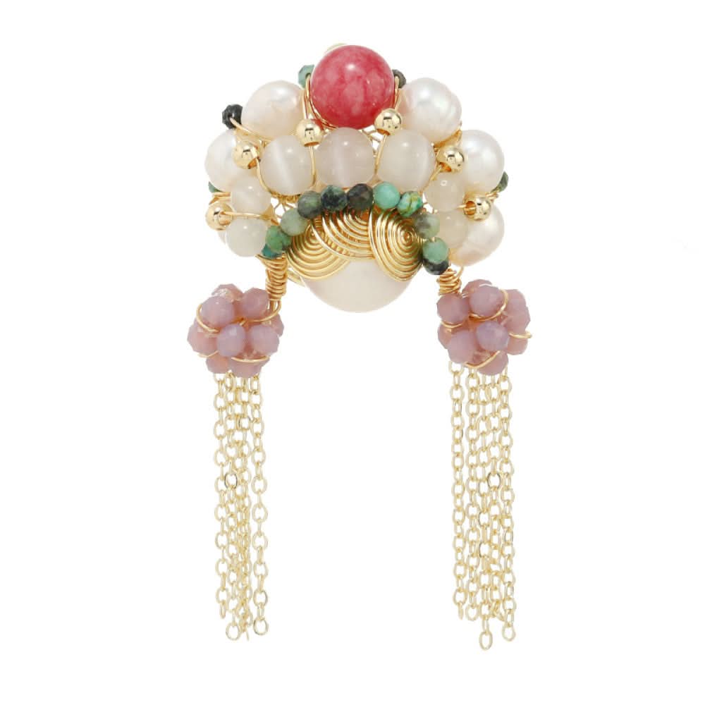 This artisan-crafted brooch features intricate gold wire-wrapping, showcasing a central arrangement of lustrous pearls, a vibrant red gemstone, and rich green accents. Delicate purple bead clusters dangle from either side, cascading into elegant gold tassels that sway with movement. Perfect for adding a touch of bohemian luxury to blazers, scarves, or dresses, this statement piece is a true work of wearable art. 03