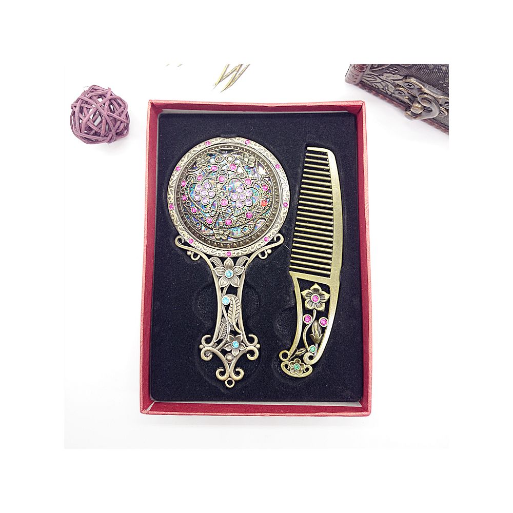 A single handcrafted wooden comb with ornate metal details placed inside a gift box