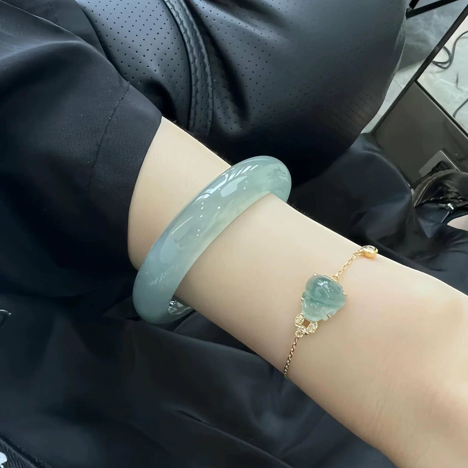 Hand wearing icy blue water jade bangle and gold chain jade charm bracelet set, stackable natural jade jewelry