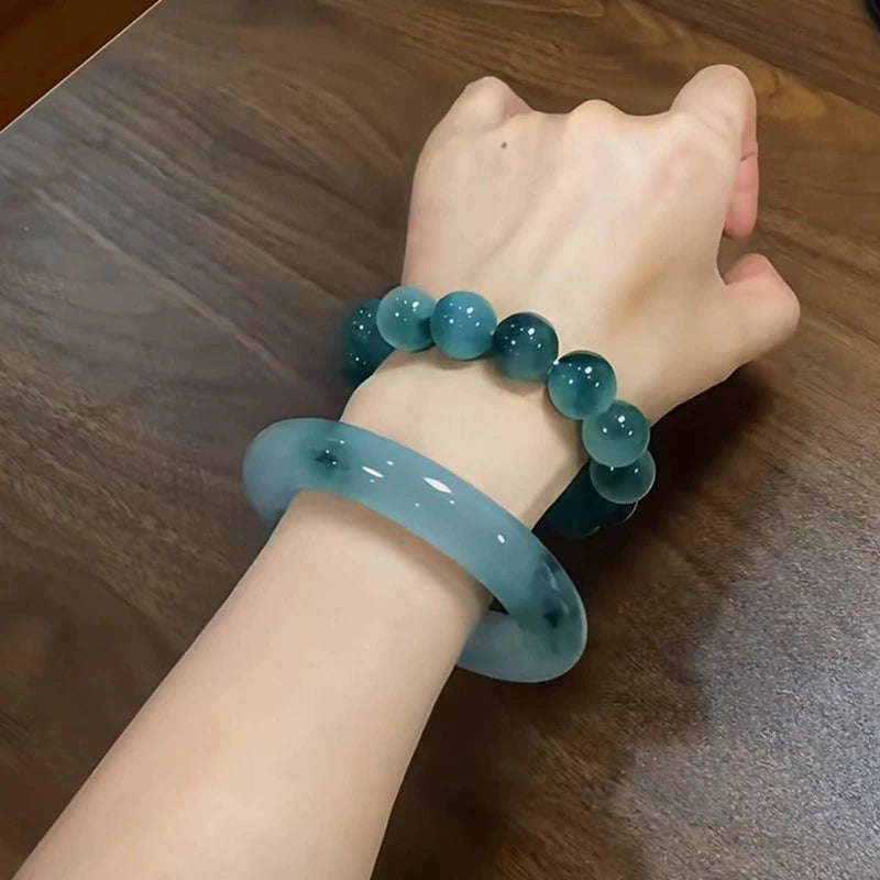Icy blue water jade bracelet and bangle set on wrist, natural jade jewelry