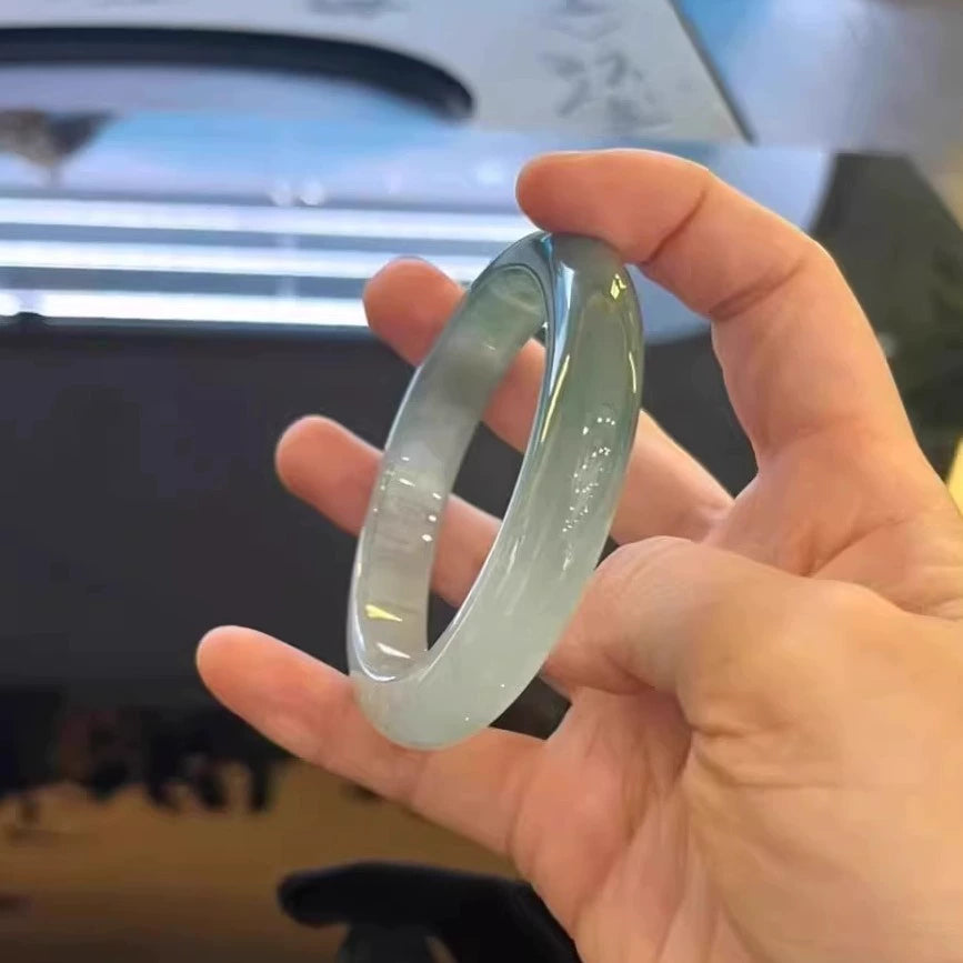 Woman wearing icy blue water natural jade bangle, translucent Chinese jade bracelet 02
