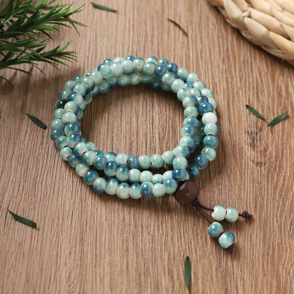 Sky-blue glazed beads, cool and refreshing, with turquoise tassel accents.