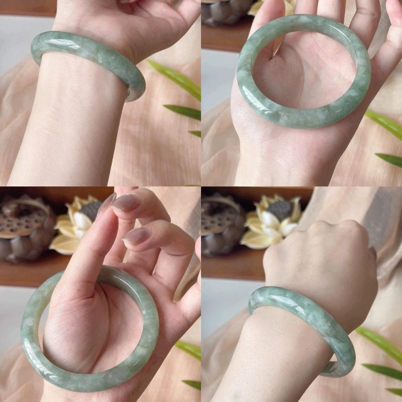 Hand holding moss green natural jade bangle 02