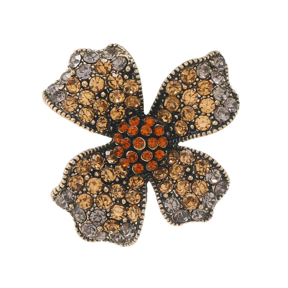 This eye-catching brooch features a striking four-petal floral design, crafted on an antiqued metal base and lavishly adorned with a dazzling array of crystals. Each petal shimmers with a gradient of clear and golden crystals, while a vibrant cluster of orange crystals anchors the center, creating a bold, layered effect. Perfect for adding a touch of vintage glamour to blazers, scarves, or evening wear, this piece blends intricate craftsmanship with timeless, eye-catching charm 03
