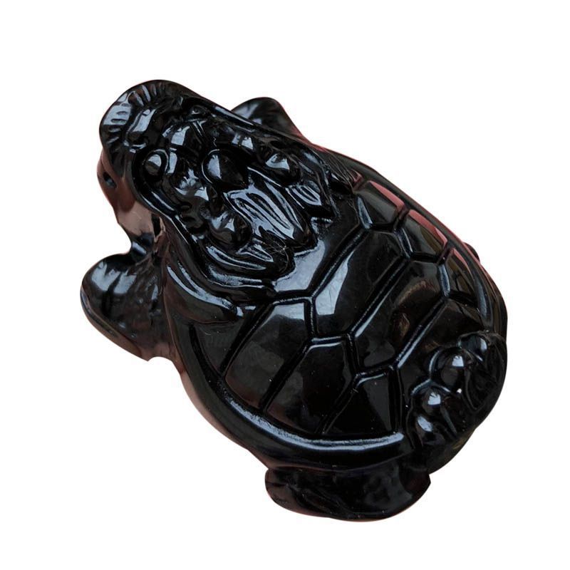 A hand - held natural black obsidian amulet carved into the shape of a dragon - turtle, showcasing fine craftsmanship and a glossy finish. 01