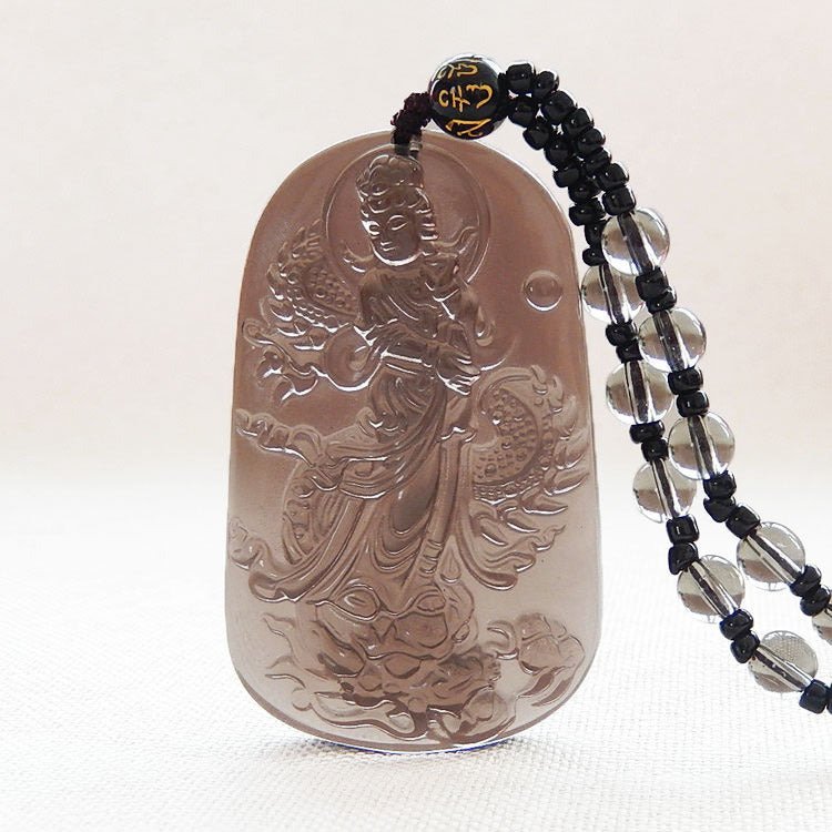 Natural ice obsidian pendant with Guanyin carving, featuring a translucent texture and traditional Chinese religious design, paired with a beaded necklace