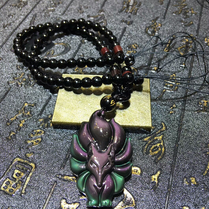 Obsidian fox pendant necklace featuring a carved fox design, black beaded chain, and jade accent piece, ideal for feng shui and spiritual jewelry collections 01