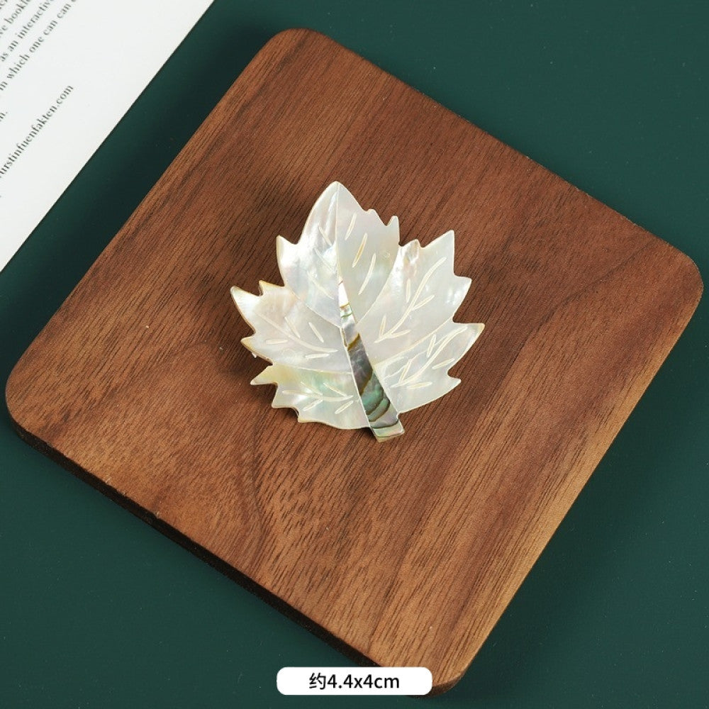 This elegant butterfly brooch is handcrafted from natural mother-of-pearl and iridescent abalone shell, showcasing unique organic patterns. A perfect nature-inspired accessory to elevate any outfit 02