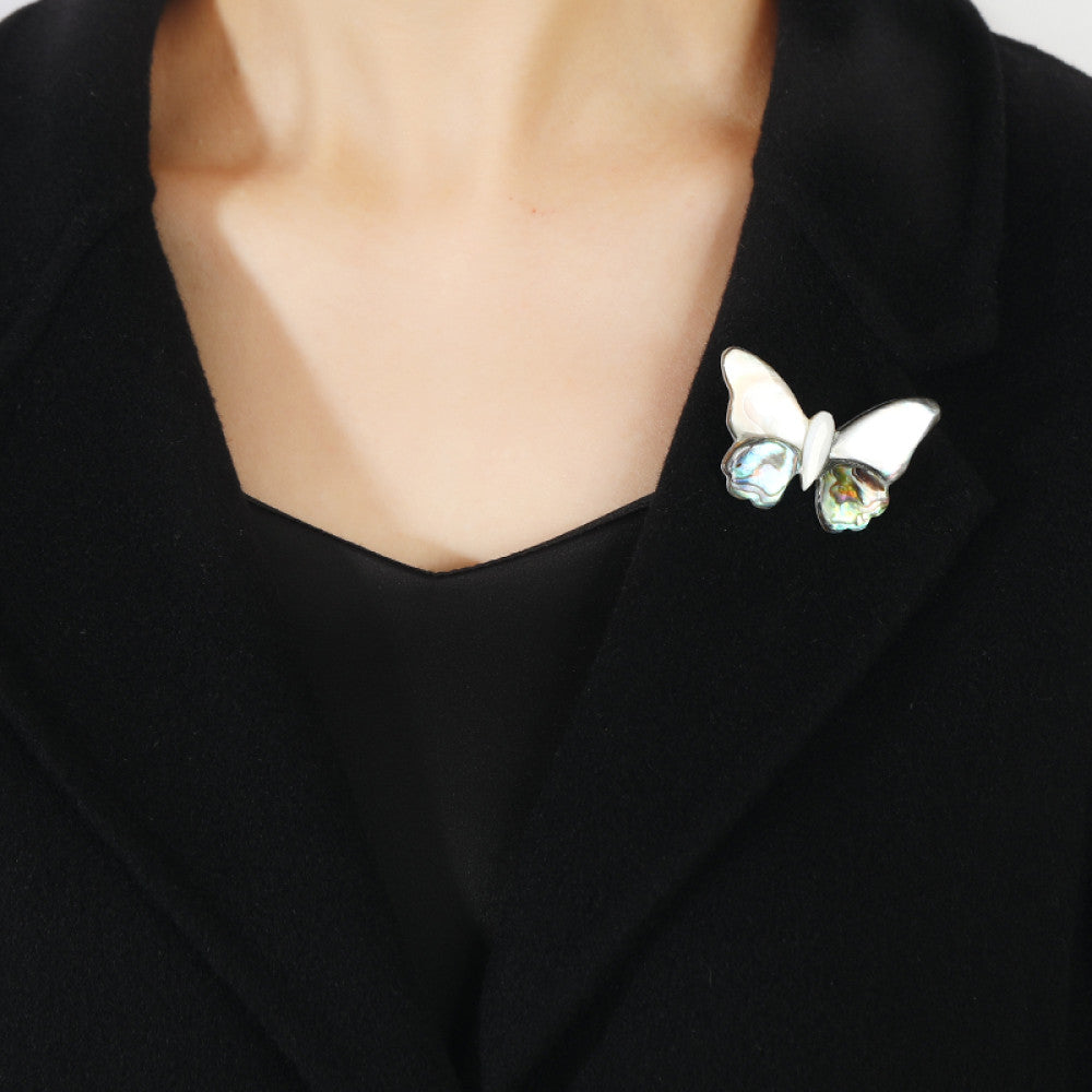 This elegant butterfly brooch is handcrafted from natural mother-of-pearl and iridescent abalone shell, showcasing unique organic patterns. A perfect nature-inspired accessory to elevate any outfit 07