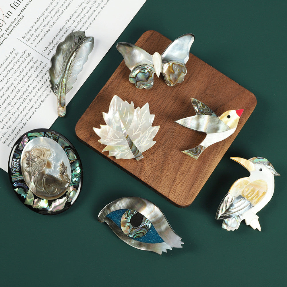 This elegant butterfly brooch is handcrafted from natural mother-of-pearl and iridescent abalone shell, showcasing unique organic patterns. A perfect nature-inspired accessory to elevate any outfit 08