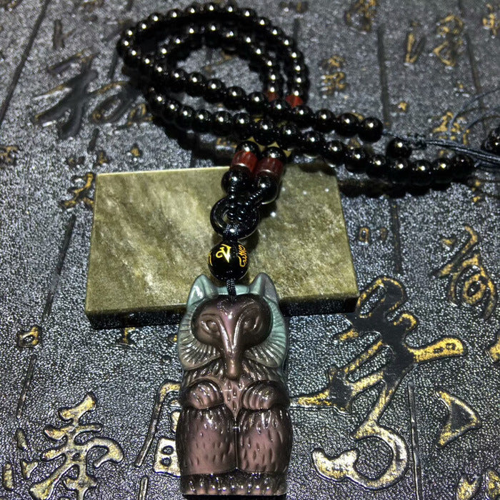 Obsidian fox pendant necklace featuring a carved fox design, black beaded chain, and jade accent piece, ideal for feng shui and spiritual jewelry collections
