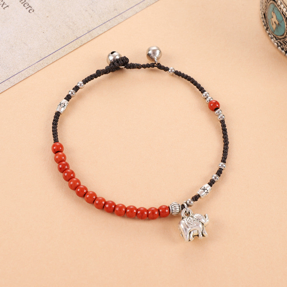 Red beads with round silver tag, auspicious and warm.