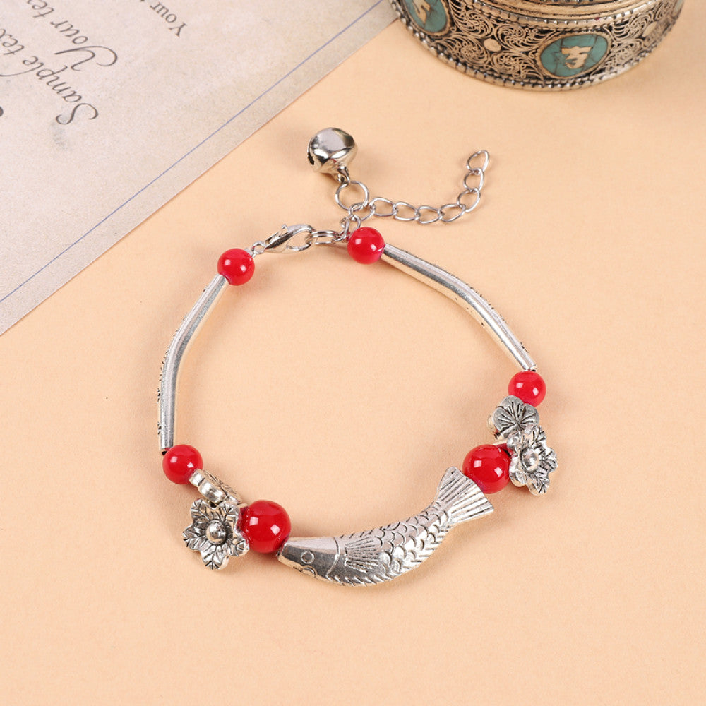 Bold red beads paired with silver discs, eye-catching contrast.