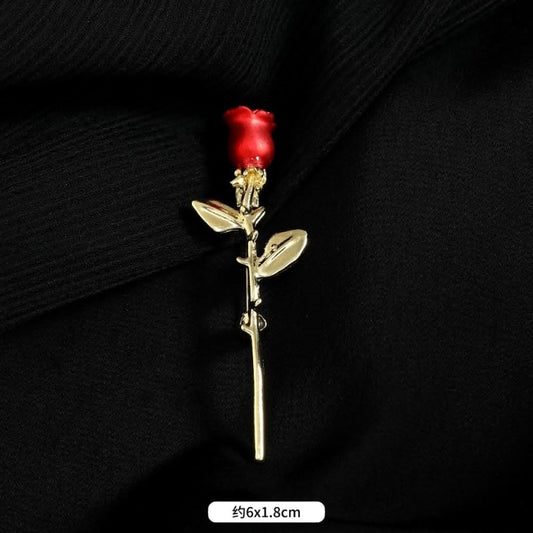 This elegant brooch features vibrant red petals with a lustrous pearl center, set on a gold stem with sparkling crystal accents. A romantic, eye-catching accessory 01