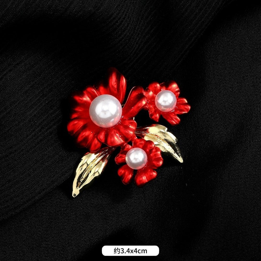 This elegant brooch features vibrant red petals with a lustrous pearl center, set on a gold stem with sparkling crystal accents. A romantic, eye-catching accessory 03