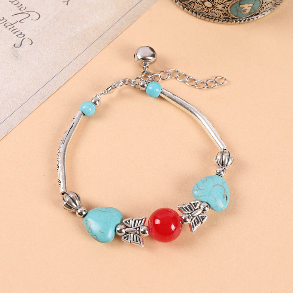 Heart-shaped red and turquoise beads, sweet romantic touch.
