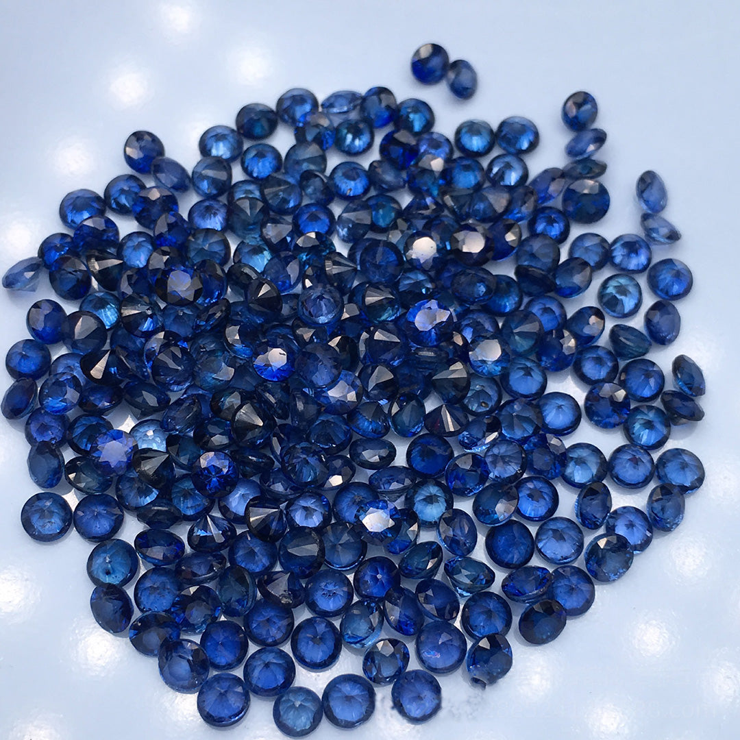 A collection of round sapphires on a white background, showcasing a jewel-quality finish.