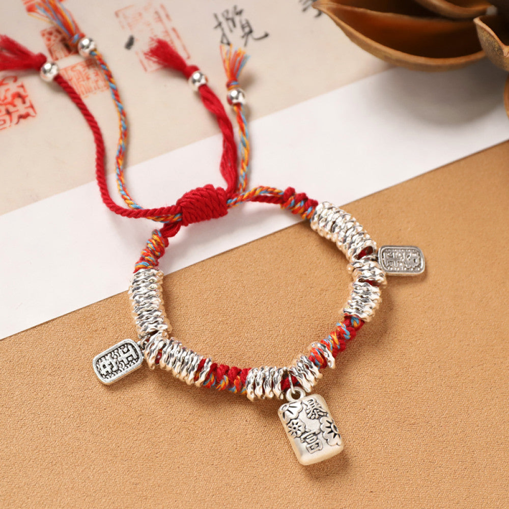 Simple red braid with rectangular silver tags, clean and classic.