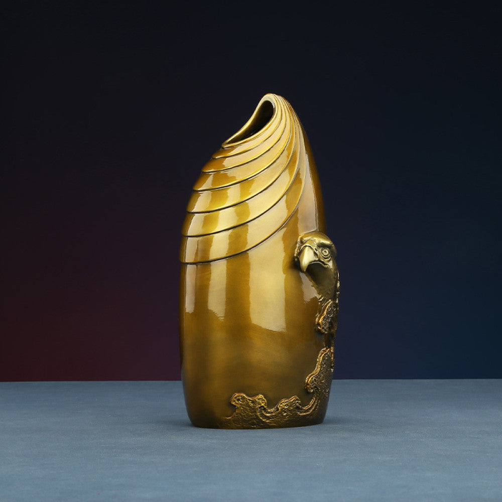 Brass eagle sculpture with textured details, placed on blue surface against dark gradient background 02