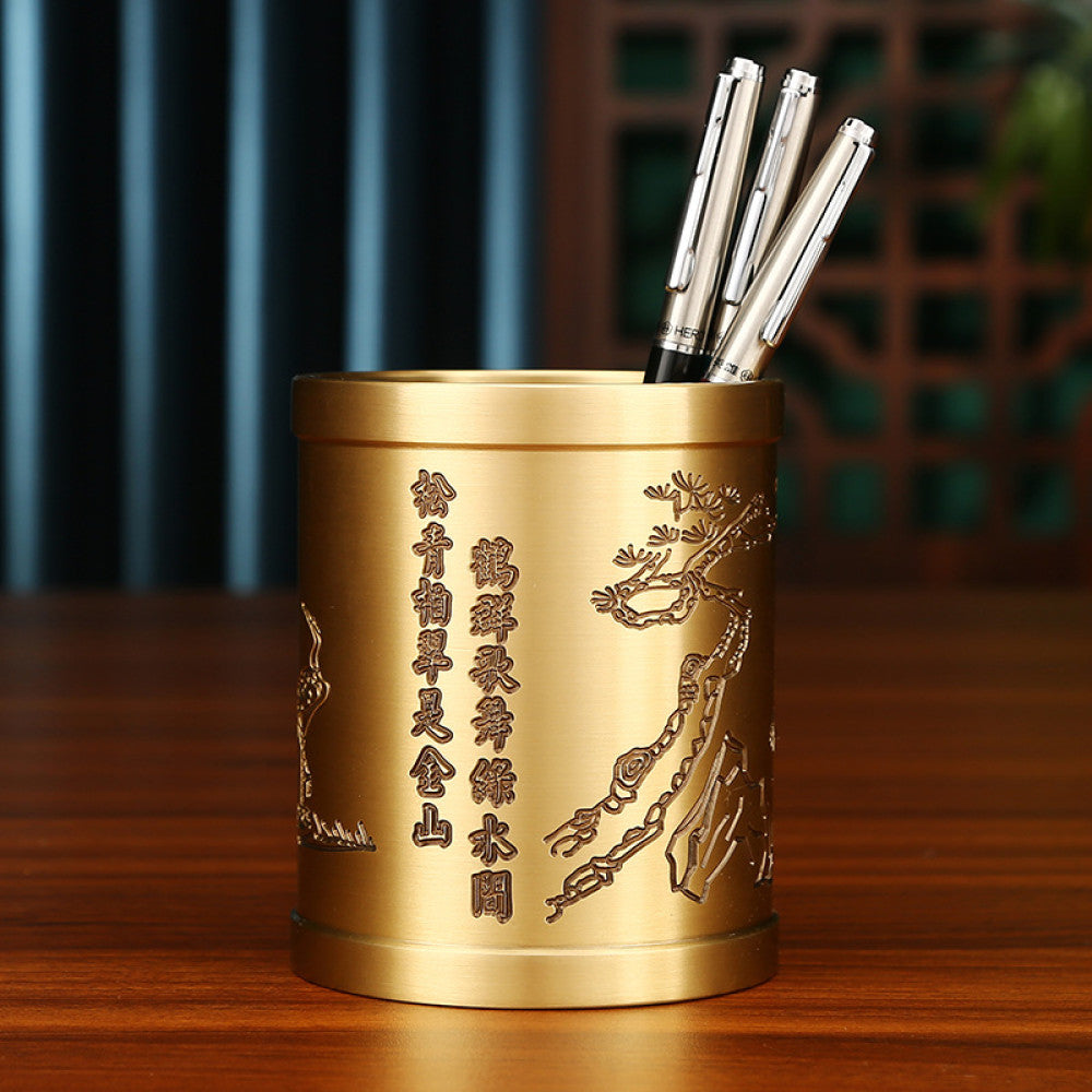 Brass pen holder with ox carving and Chinese characters, holding pens, placed on a wooden table against a traditional Chinese background 03