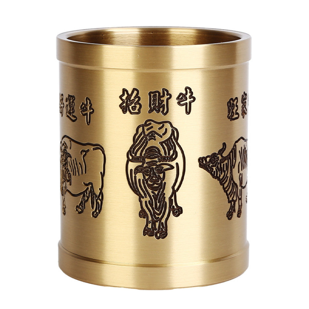 Brass pen holder with ox carving and Chinese characters, holding pens, placed on a wooden table against a traditional Chinese background 05
