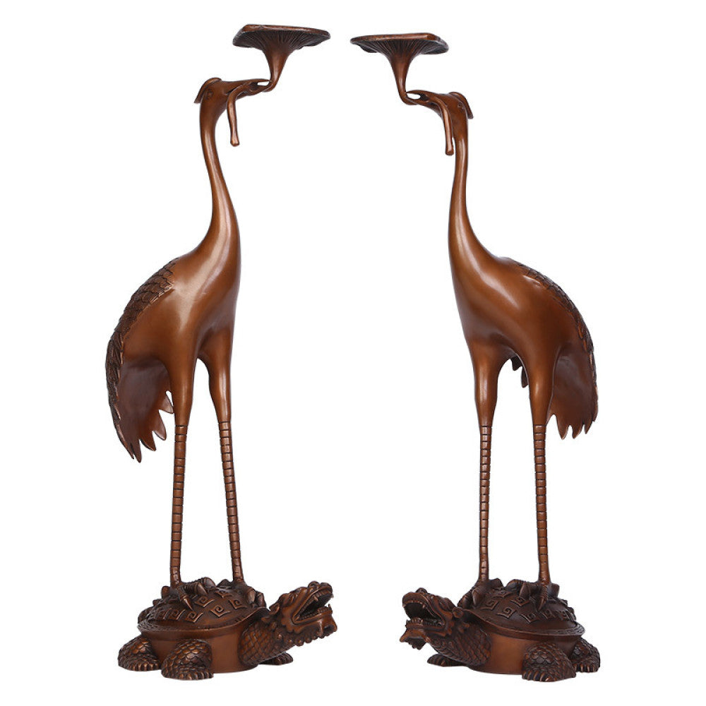 Pair of traditional Chinese bronze crane and tortoise candle holders, with cranes standing on tortoises, against a gradient teal - green background 01