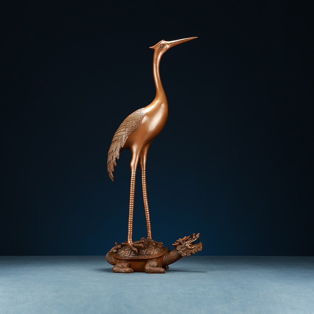 Traditional Chinese bronze crane statue standing on a dragon turtle, displayed against a dark blue background
