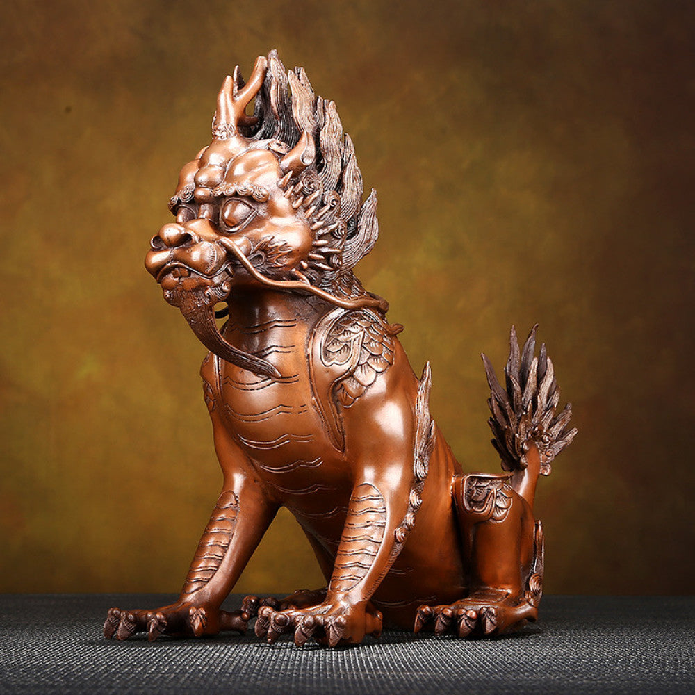 Bronze Qilin statue with intricate carvings, traditional Chinese auspicious mythical beast decor, placed on a dark surface against a warm brown background