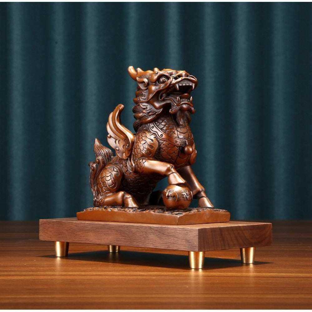 Traditional Chinese bronze Qilin statue with wings, standing on a yuanbao ingot, placed on a wooden base against a gray background 01