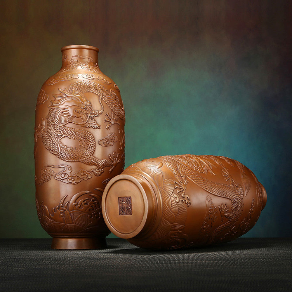 Pair of traditional Chinese bronze vases with intricate dragon carvings against a textured dark background 03
