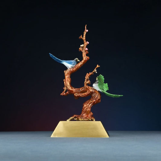 Traditional Chinese enameled sculpture of colorful birds on a flowering branch, placed on a golden base against a dark background 01