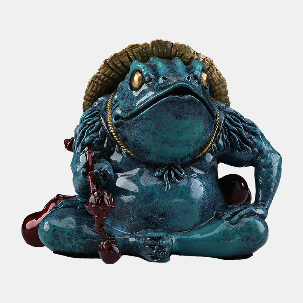 Colorful Chinese money toad statue with a straw hat, holding a ruyi - like ornament, placed on a green surface against a dark background 01