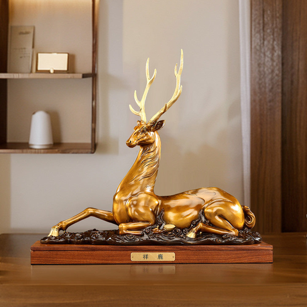 Traditional Chinese golden bronze deer statue in a reclining pose with detailed antlers, placed on a wooden base against a dark green background with traditional books 02