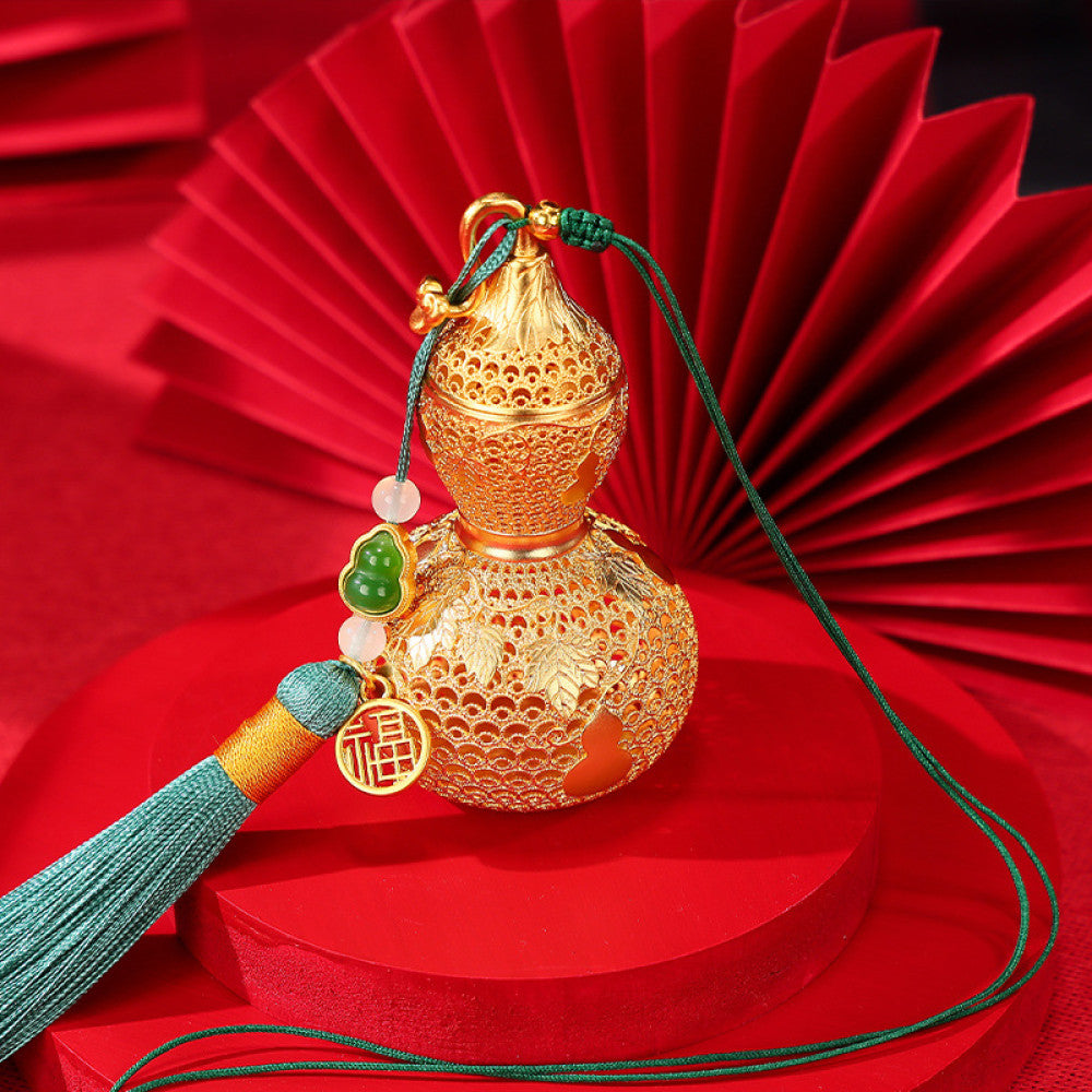 Traditional Chinese golden gourd hanging ornament with intricate openwork, tassel, and jade accents, set against a red background with Chinese lattice design 01