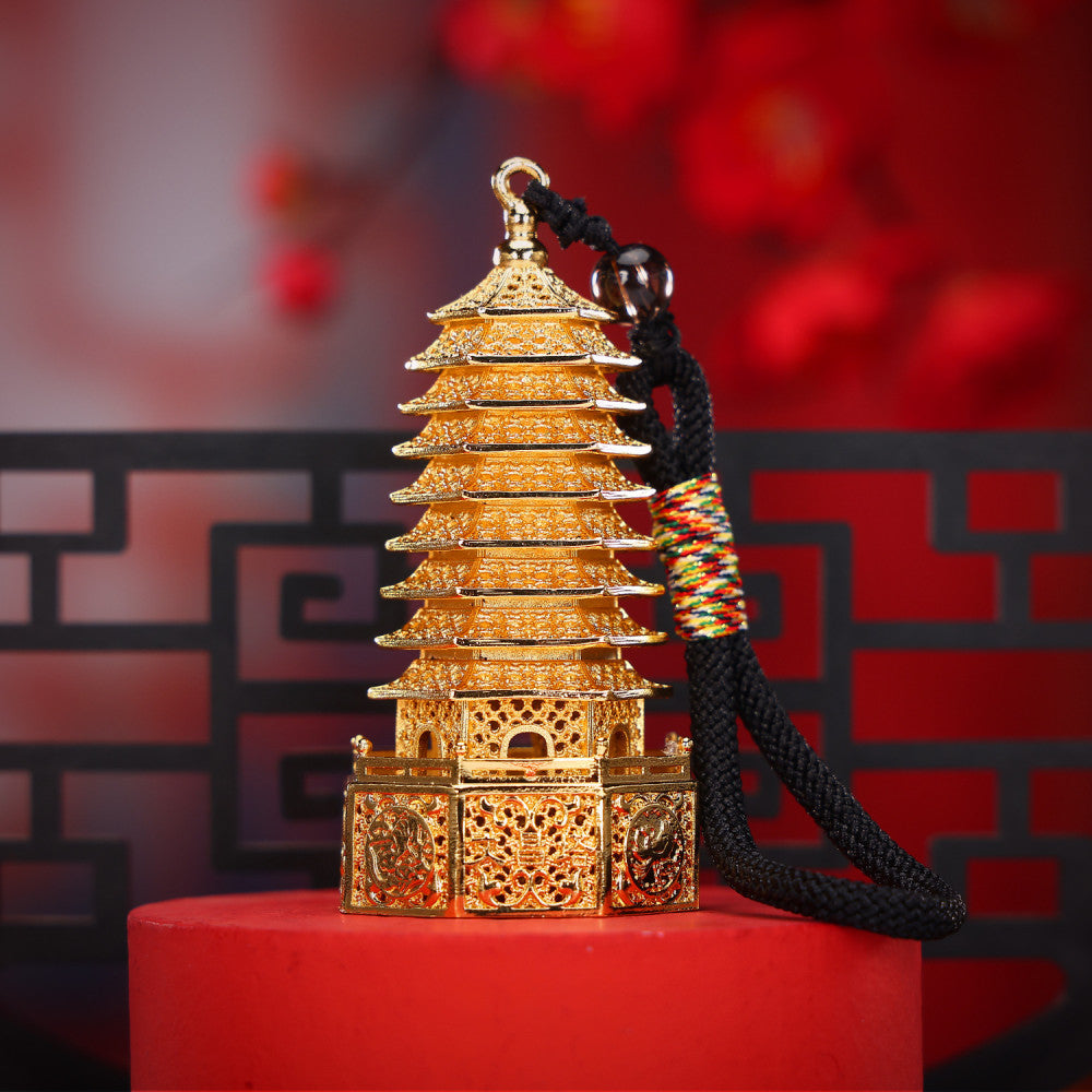 Golden Chinese Wenchang Tower pendant with intricate carvings, attached to a black cord with colorful details and beads, isolated on white backgroun 02