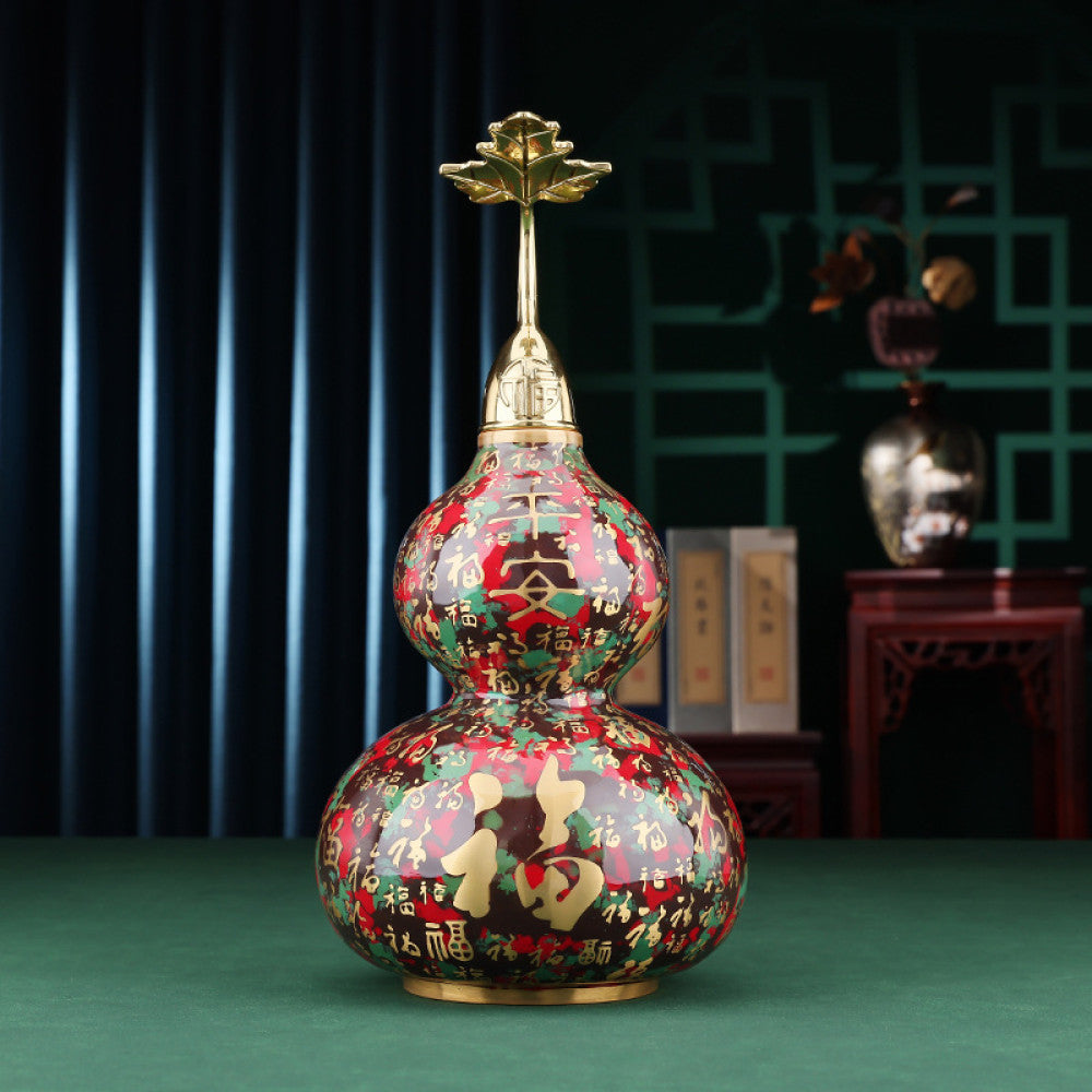 Colorful enameled Chinese gourd decoration with golden accents, placed on green surface in traditional interior setting 01