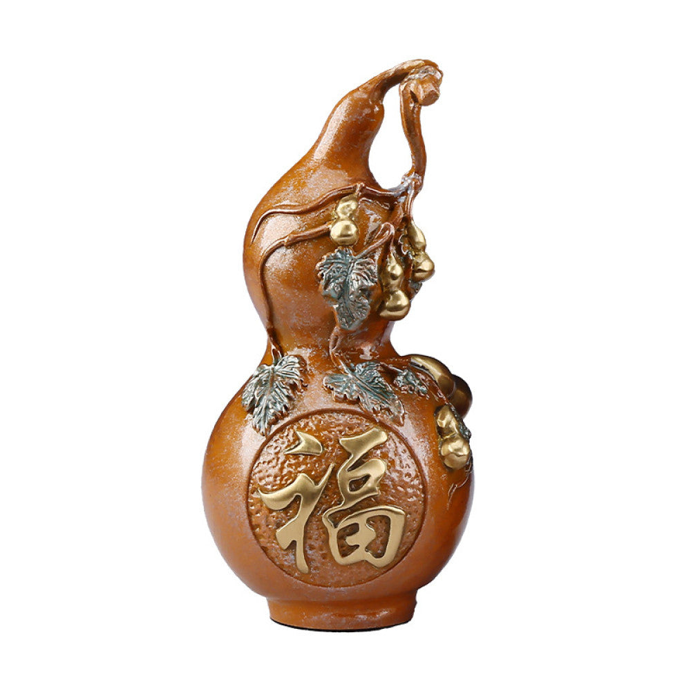 Traditional Chinese gourd statue with "Fu" luck character, colorful enamel details, placed on green surface against dark background
