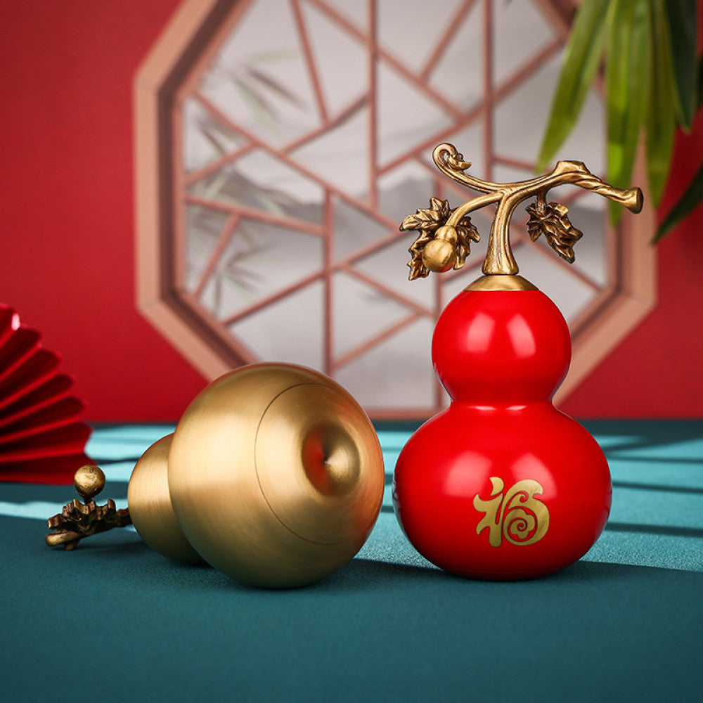 raditional Chinese red and gold gourd ornaments (one with "Fu" character) displayed on a teal surface, with a red fan and lattice window in the background