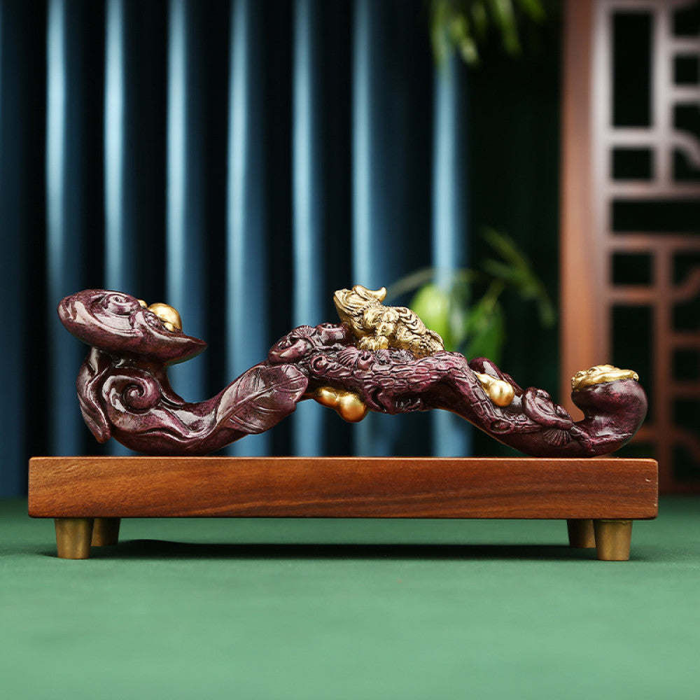 Traditional Chinese ruyi sculpture with golden pixiu and pearl details, placed on wooden base against dark blue curtain and traditional lattice background