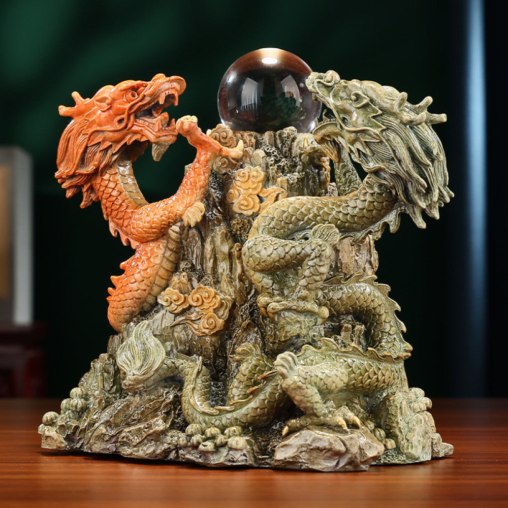 Two dragons crystal ball statue with intricate details, a Feng Shui symbol of good fortune, displayed as elegant home decor on a wooden table against a dark background